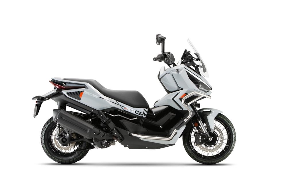 Adventure touring motorcycle in gray with a tall windshield and rugged dual-sport tires, shown from the side